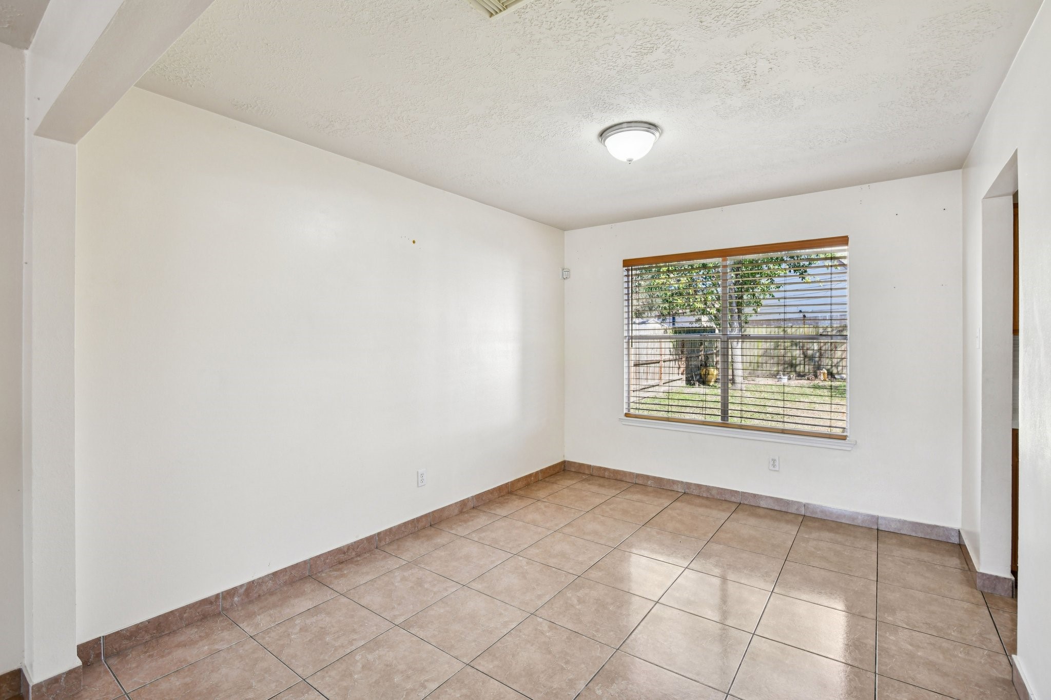 12270 Cobbs Creek Road Houston, TX 77067 - Photo 10 of 42 a view of an empty room with a window