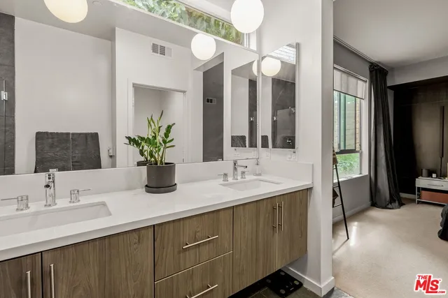 a bathroom with a double vanity sink and a mirror