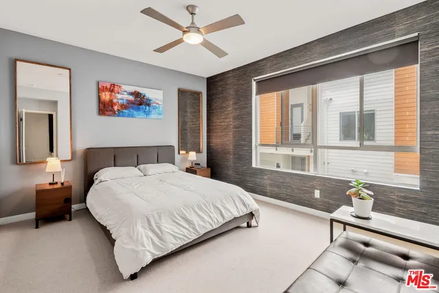 a bedroom with a bed and a window