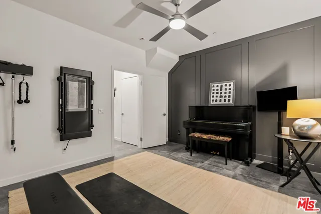a living room with furniture a piano and a flat screen tv
