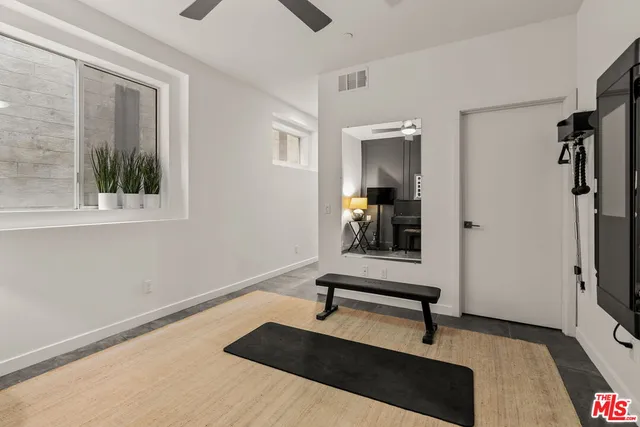 a view of a room with gym equipment and a window