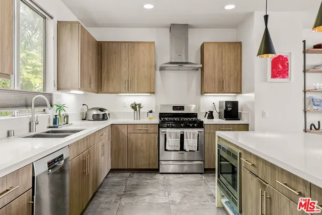 a kitchen with a sink stove top oven and cabinets