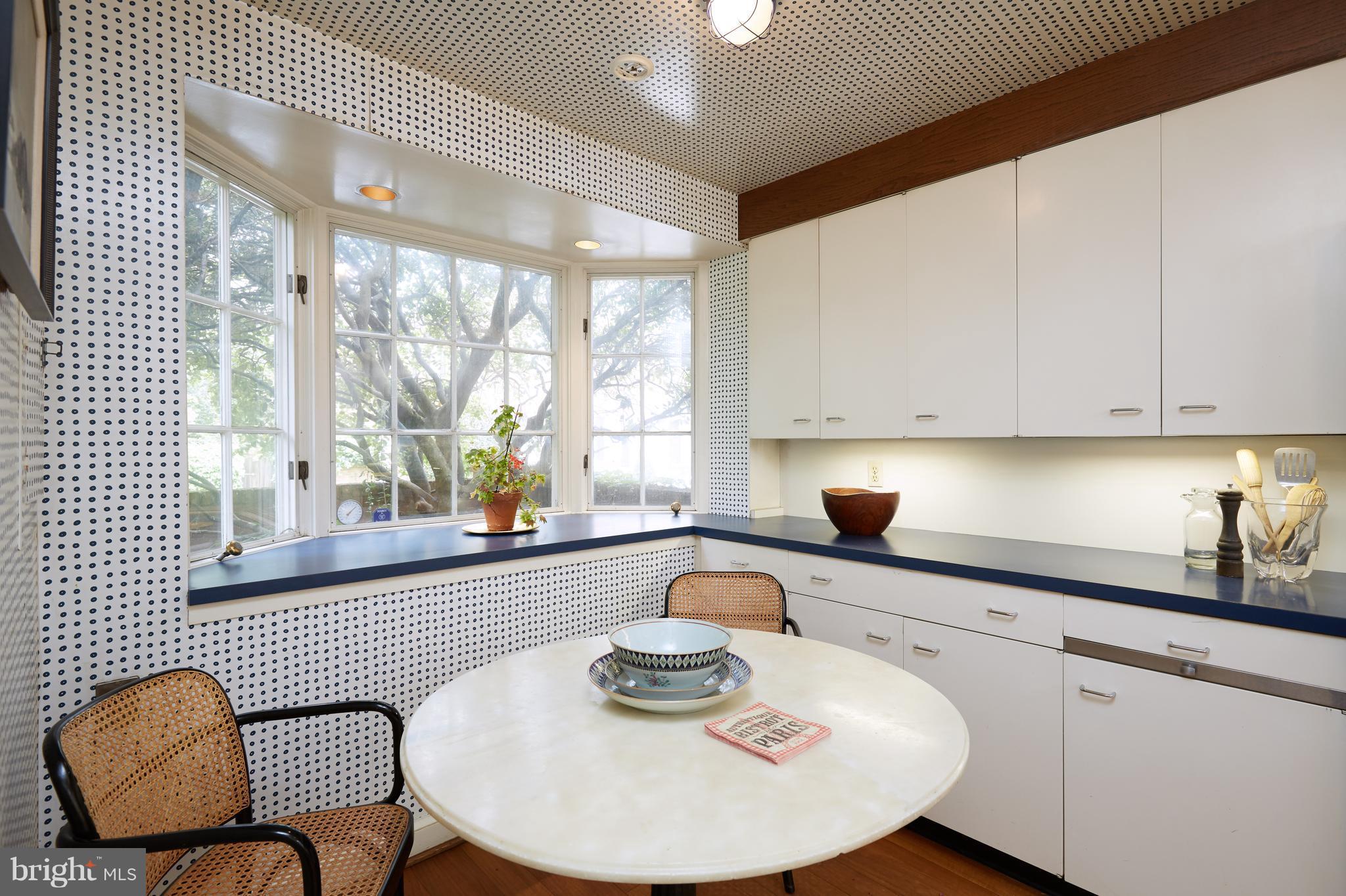 3033 West Ln Keys Northwest Washington, DC 20007 - Photo 13 of 30 a kitchen with a white cabinets and chairs