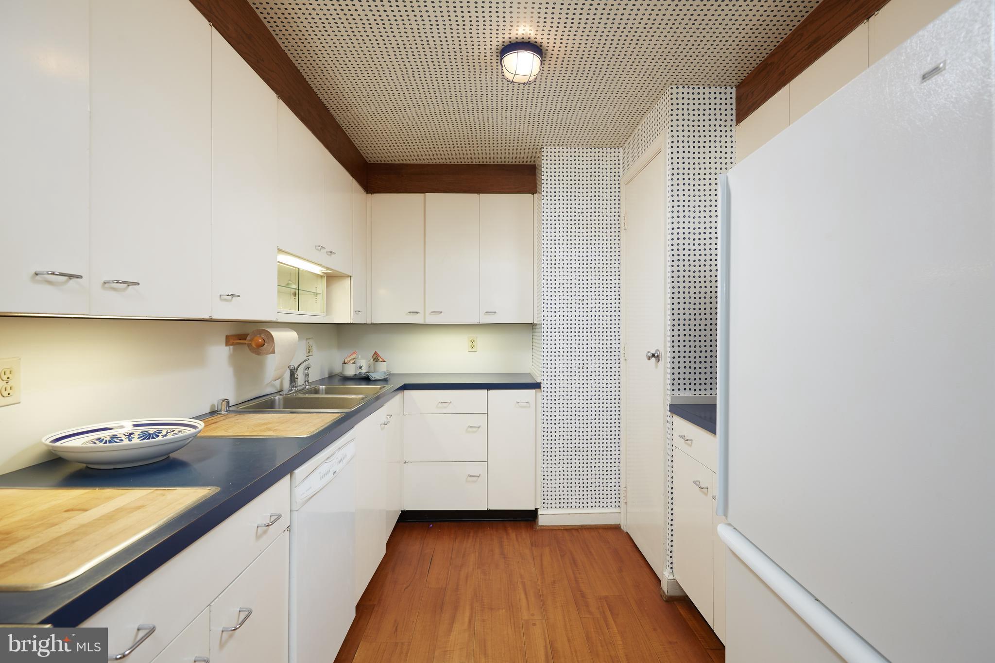 3033 West Ln Keys Northwest Washington, DC 20007 - Photo 14 of 30 a kitchen with a sink and a stove top oven