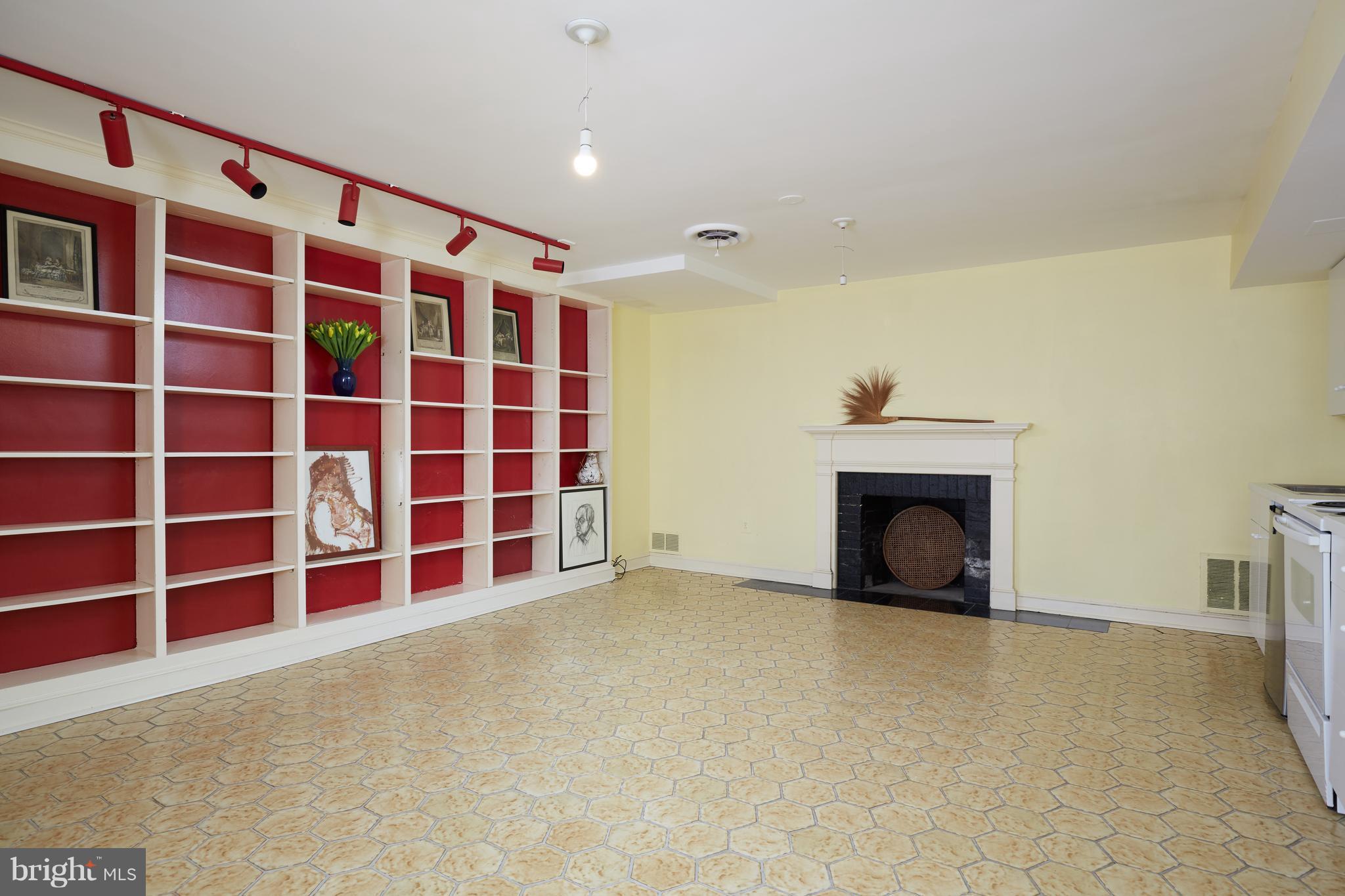 3033 West Ln Keys Northwest Washington, DC 20007 - Photo 28 of 30 a view of an empty room with a fireplace and a cabinet
