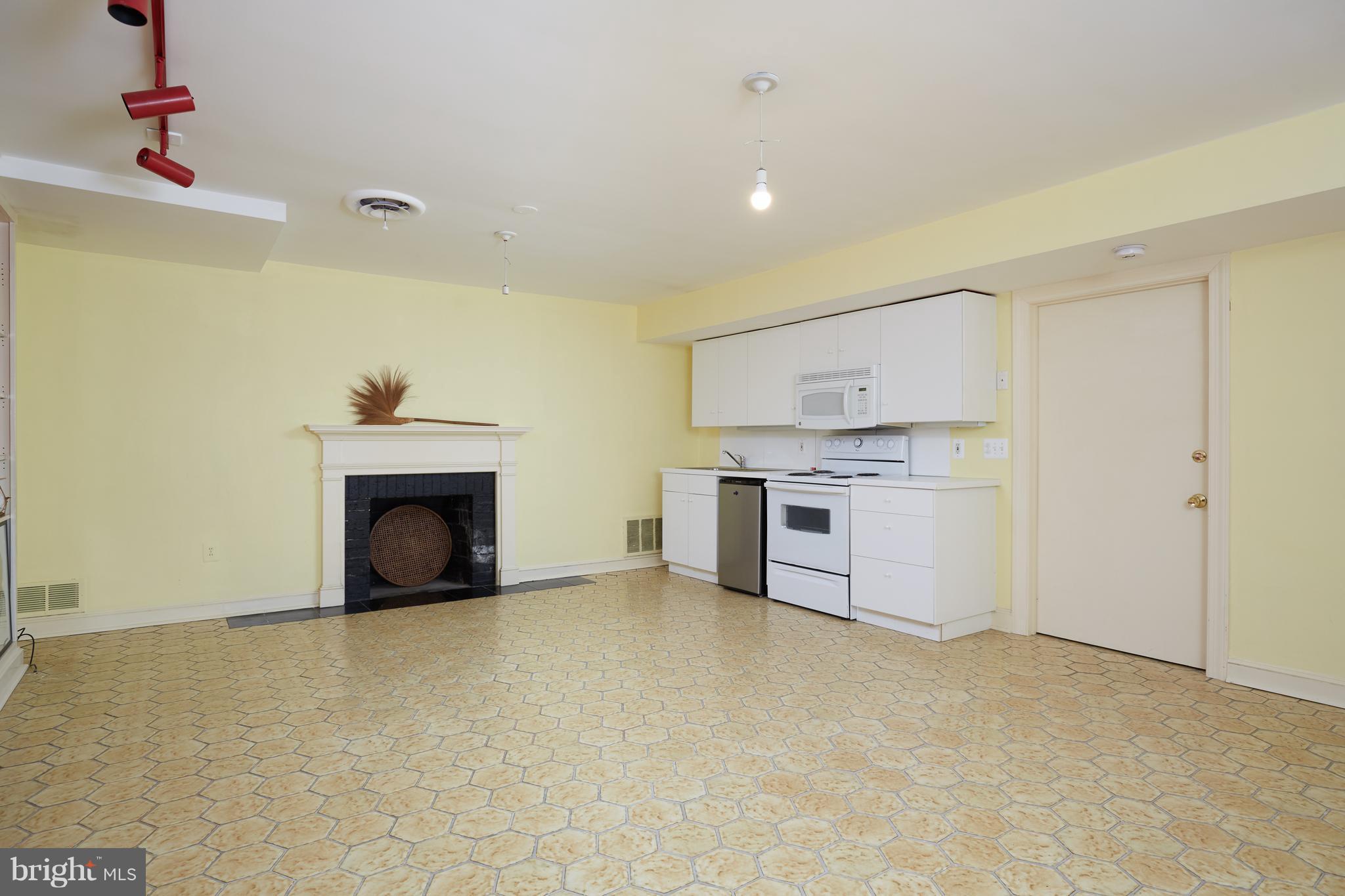 3033 West Ln Keys Northwest Washington, DC 20007 - Photo 29 of 30 a view of a kitchen with a sink cabinets and a fireplace