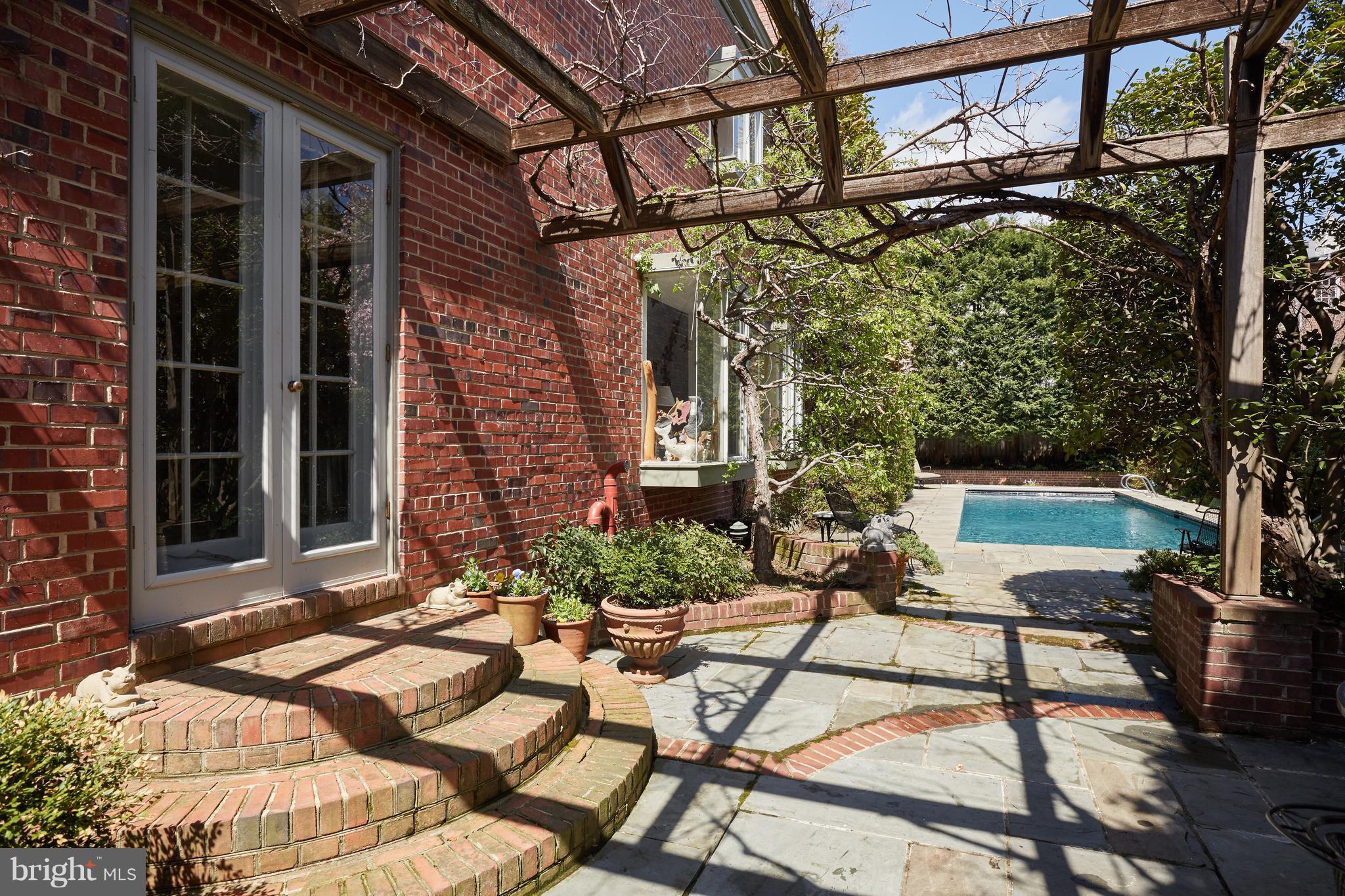 3033 West Ln Keys Northwest Washington, DC 20007 - Photo 4 of 30 a view of a chair and tables in the back yard of the house