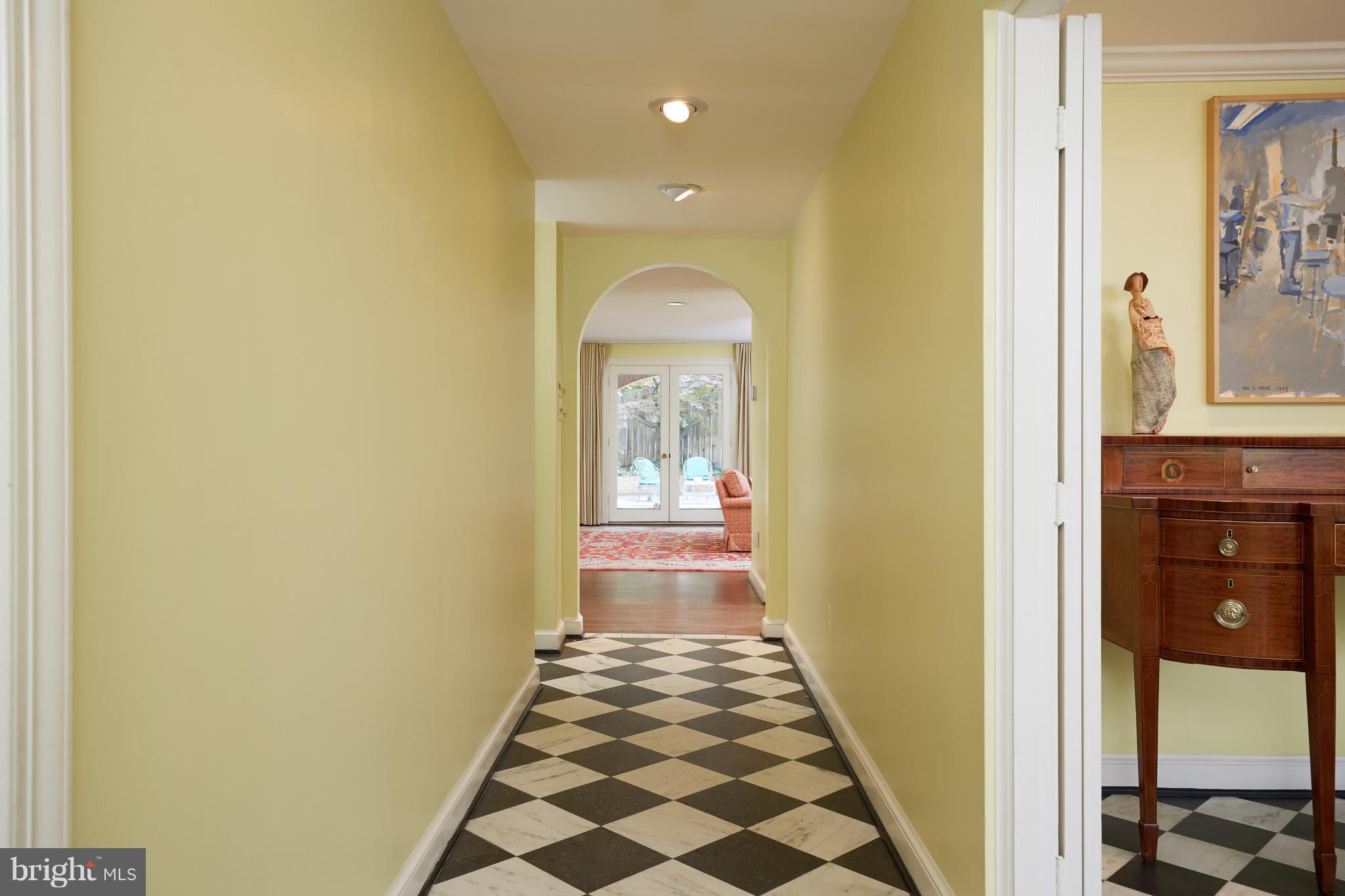 3033 West Ln Keys Northwest Washington, DC 20007 - Photo 9 of 30 a view of a hallway with wooden floor and a dining room