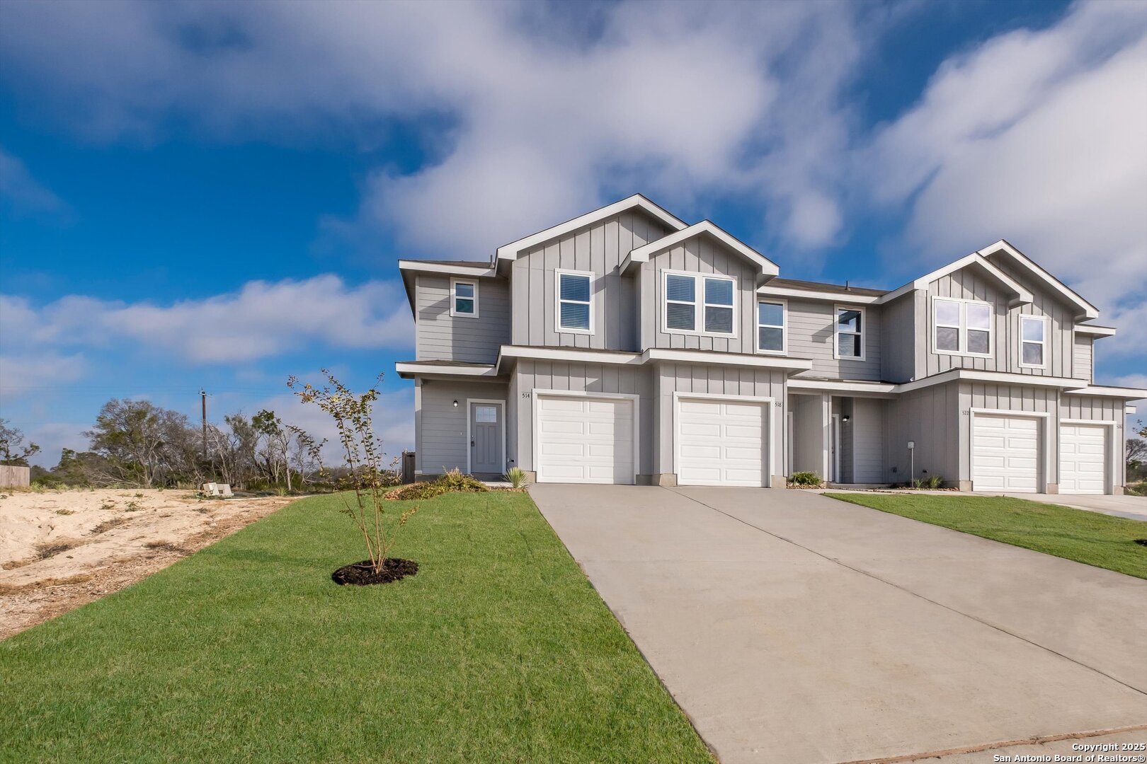 a front view of a house with a yard