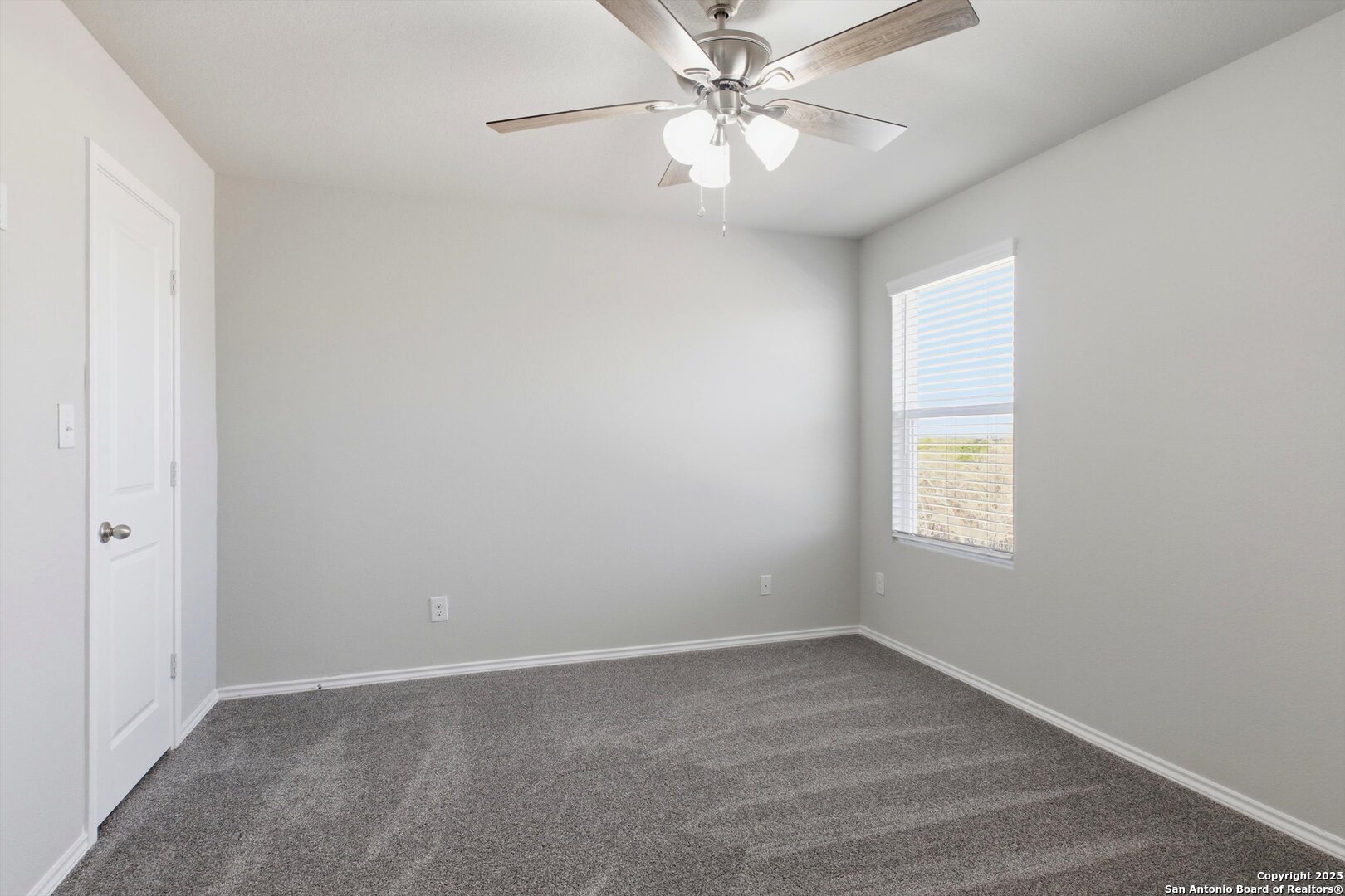 514 Abigail Alley San Antonio, TX 78253 - Photo 11 of 17 an empty room with a window and a fan