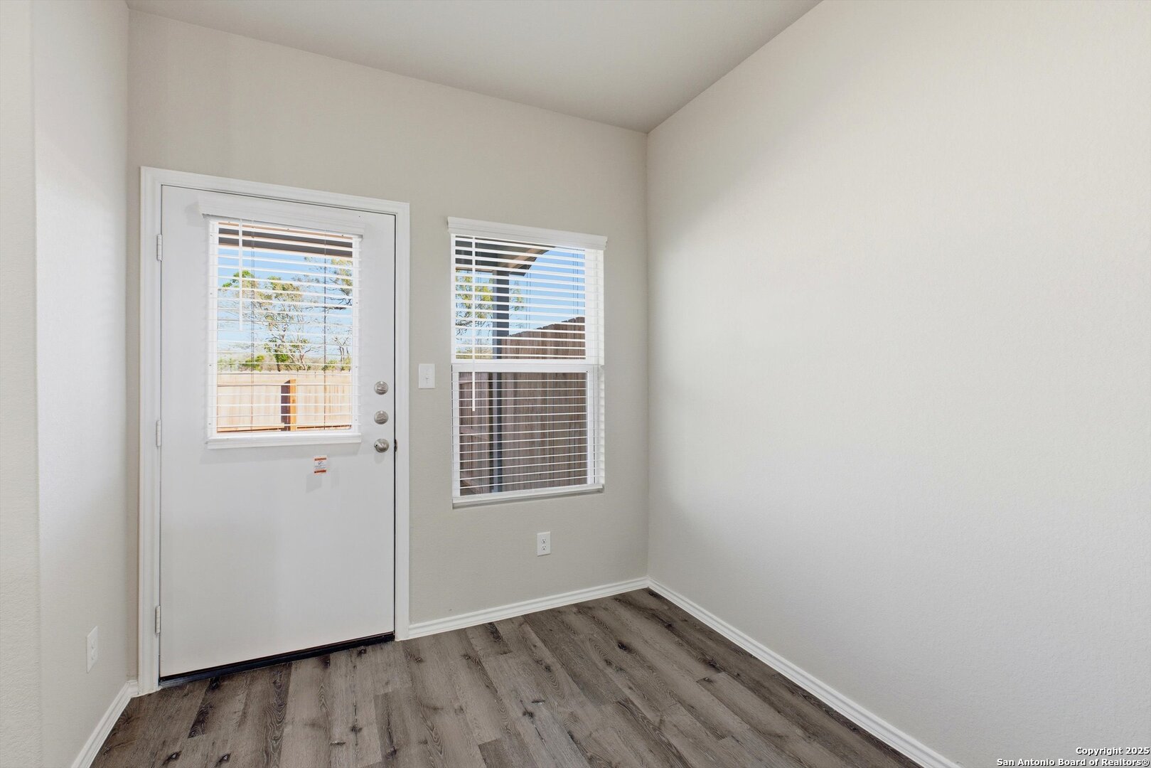 514 Abigail Alley San Antonio, TX 78253 - Photo 2 of 17 a view of an empty room with wooden floor and a window