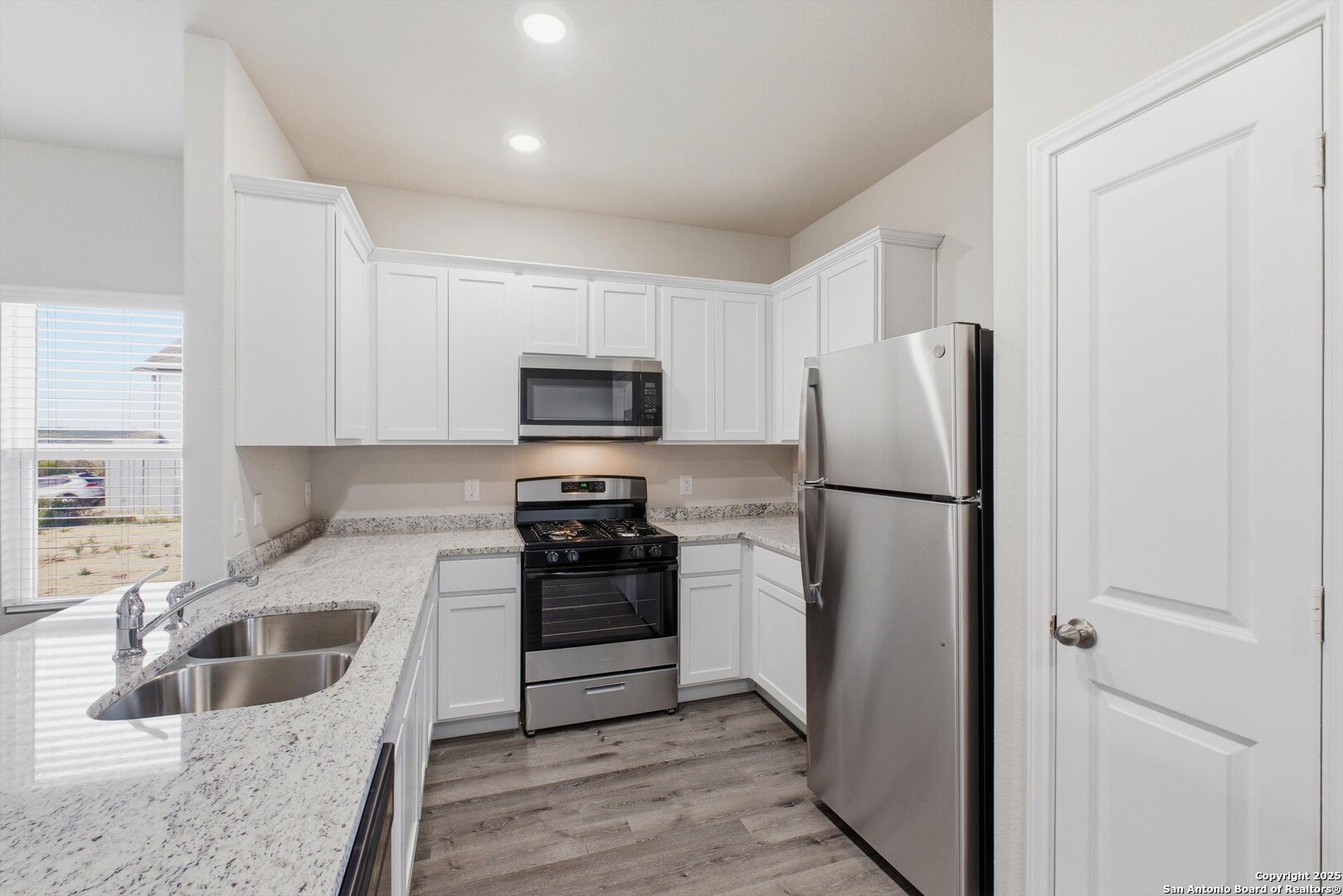 514 Abigail Alley San Antonio, TX 78253 - Photo 6 of 17 a kitchen with a refrigerator sink and microwave