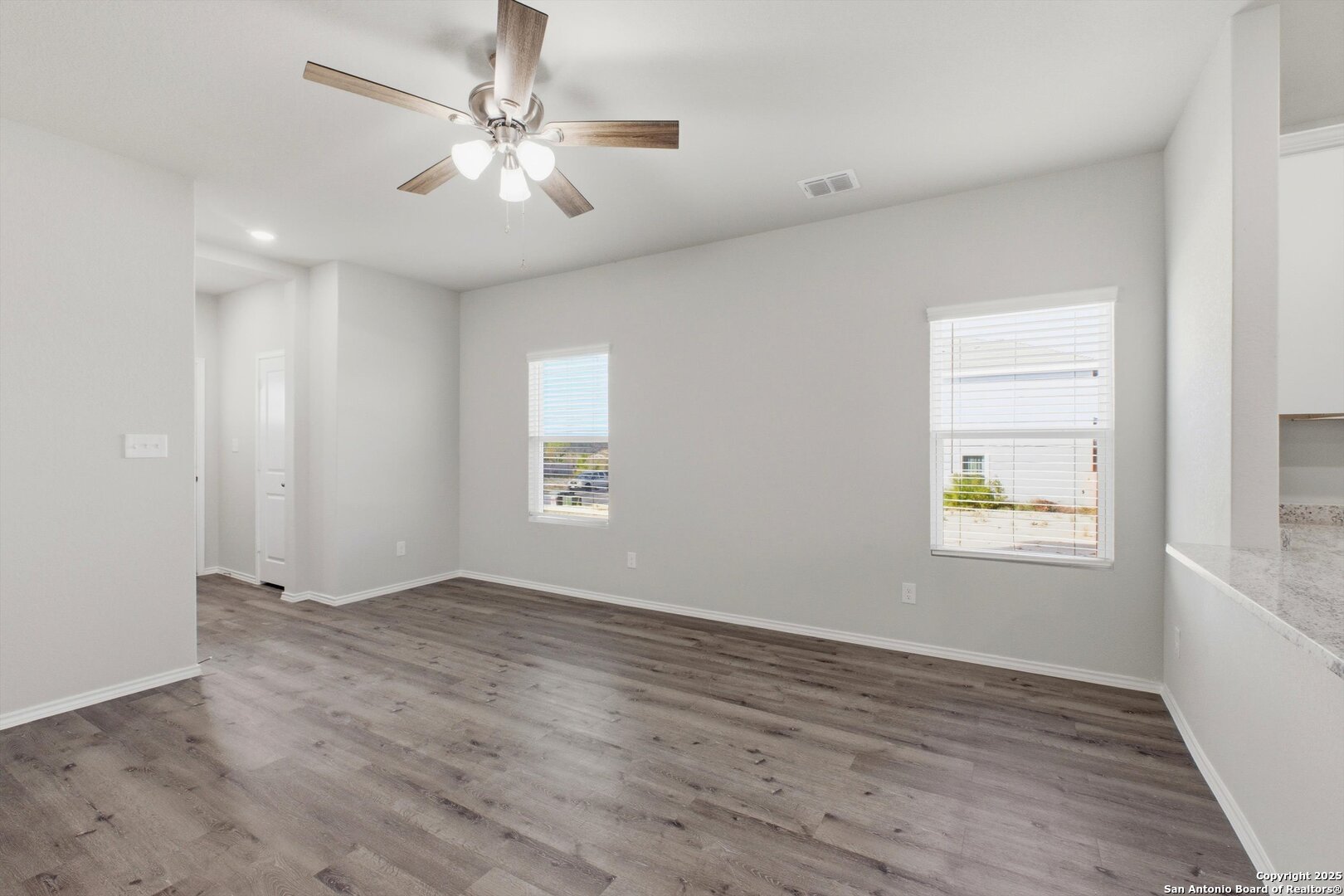 514 Abigail Alley San Antonio, TX 78253 - Photo 7 of 17 wooden floor in an empty room with a window