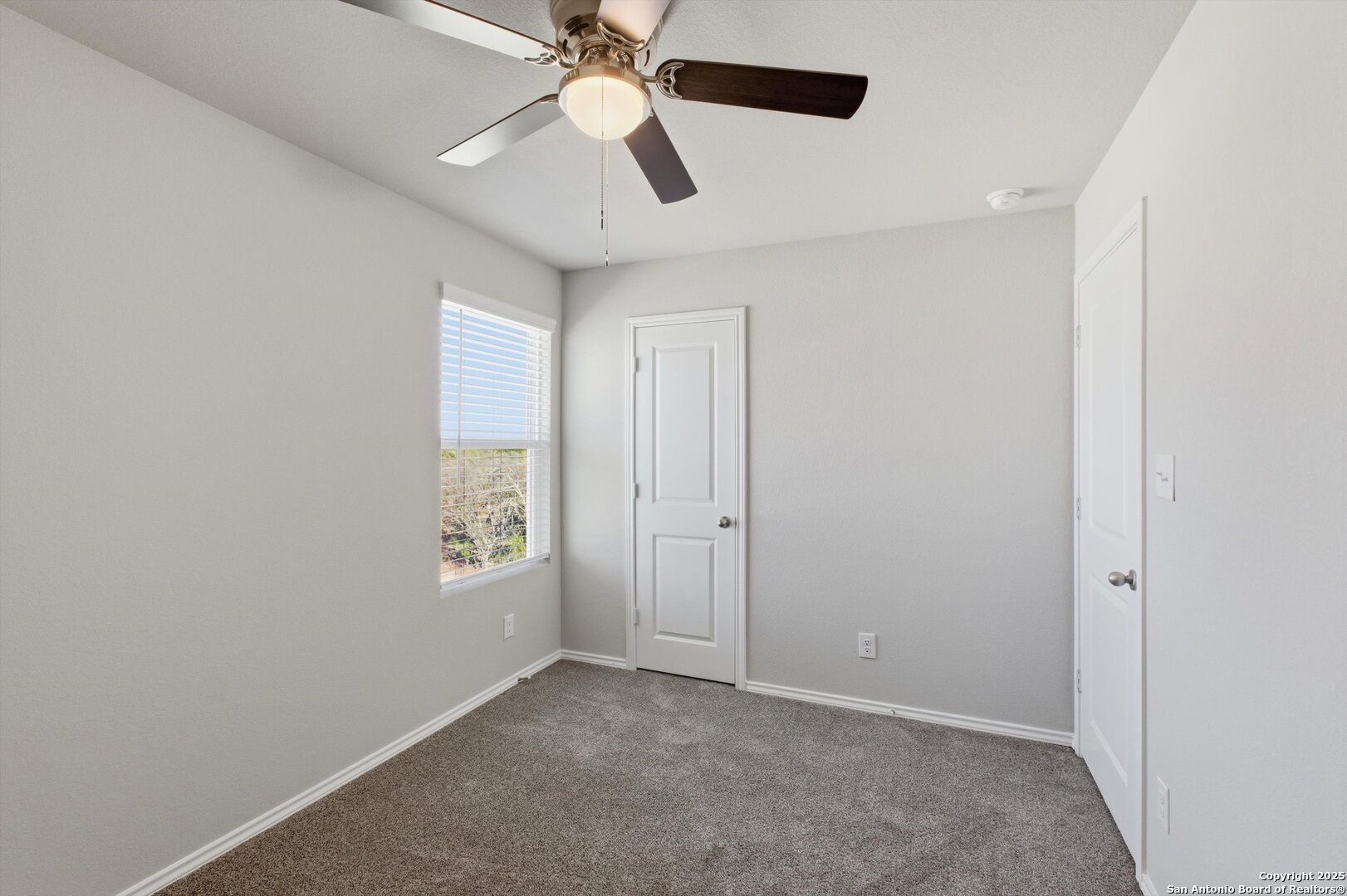 514 Abigail Alley San Antonio, TX 78253 - Photo 9 of 17 an empty room with windows and fan