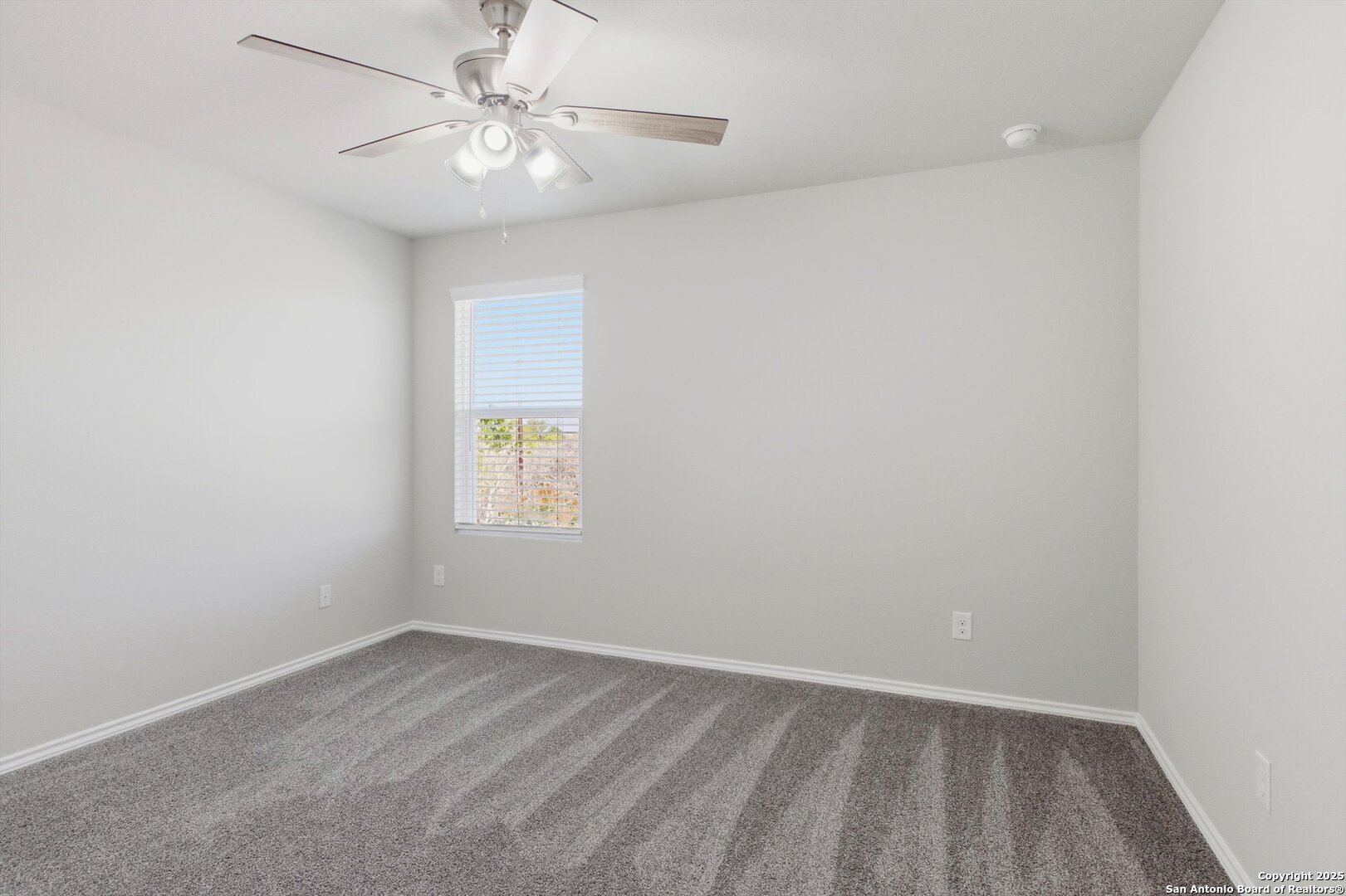 514 Abigail Alley San Antonio, TX 78253 - Photo 10 of 17 an empty room with a window and a fan