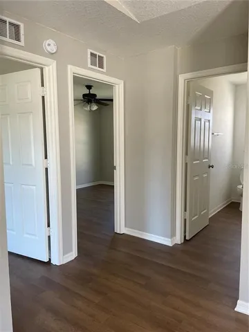 a view of a hallway with wooden floor