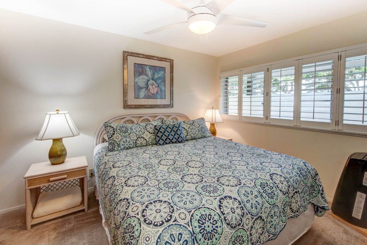 320 Papaloa Road, Unit 213 Kapaa, HI 96746 - Photo 11 of 25 a bedroom with a large bed and a window