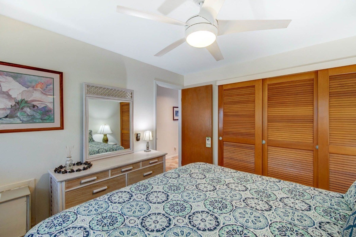 320 Papaloa Road, Unit 213 Kapaa, HI 96746 - Photo 13 of 25 a bedroom with a bed and a dresser in it