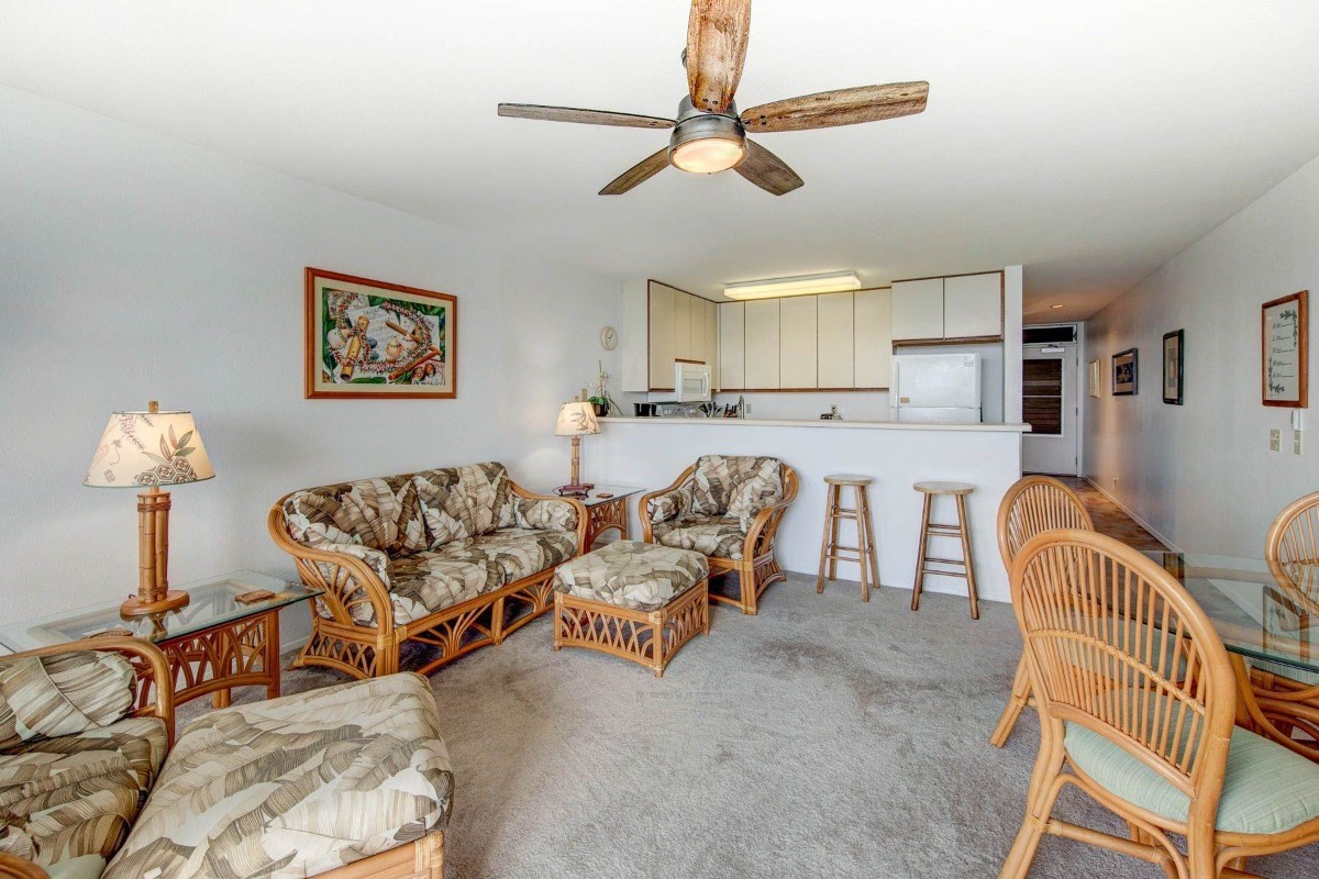 320 Papaloa Road, Unit 213 Kapaa, HI 96746 - Photo 14 of 25 a living room with furniture and a chandelier