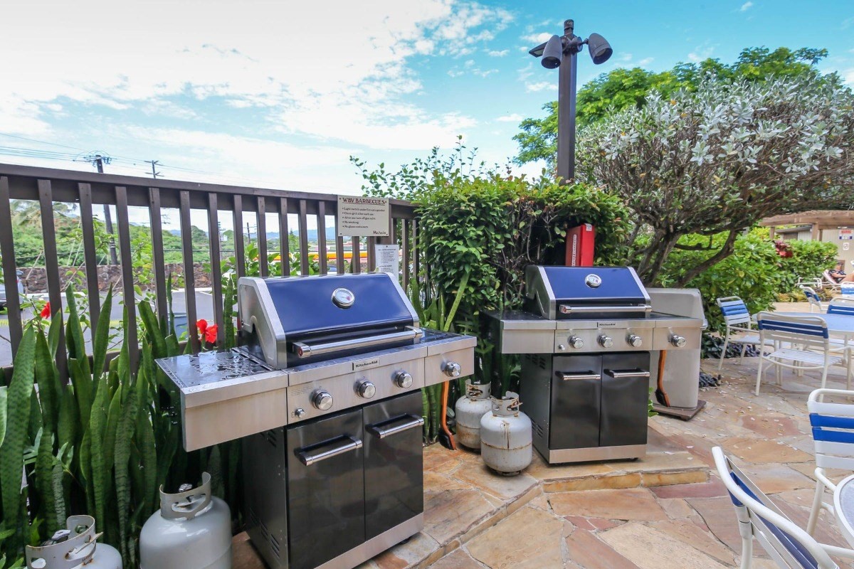 320 Papaloa Road, Unit 213 Kapaa, HI 96746 - Photo 17 of 25 a view of a chairs and table in the backyard