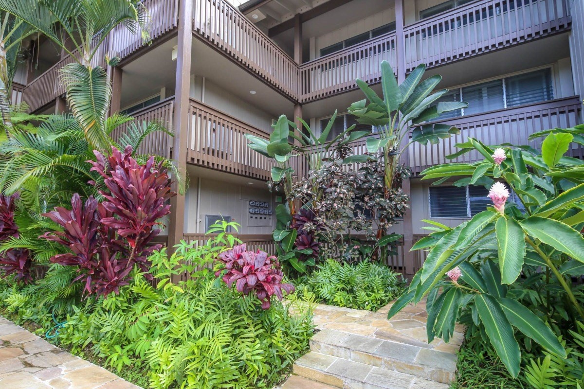 320 Papaloa Road, Unit 213 Kapaa, HI 96746 - Photo 19 of 25 a house with a flower garden in front of it