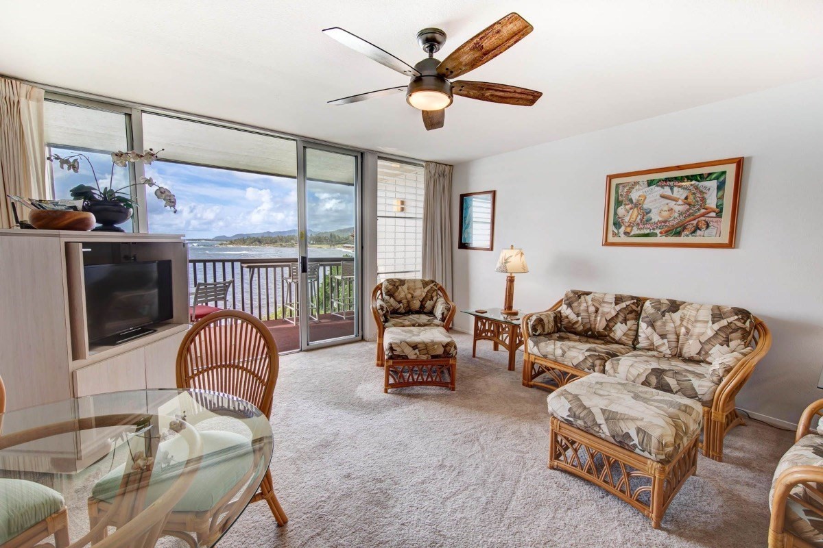 320 Papaloa Road, Unit 213 Kapaa, HI 96746 - Photo 2 of 25 a living room with furniture ceiling fan and a rug