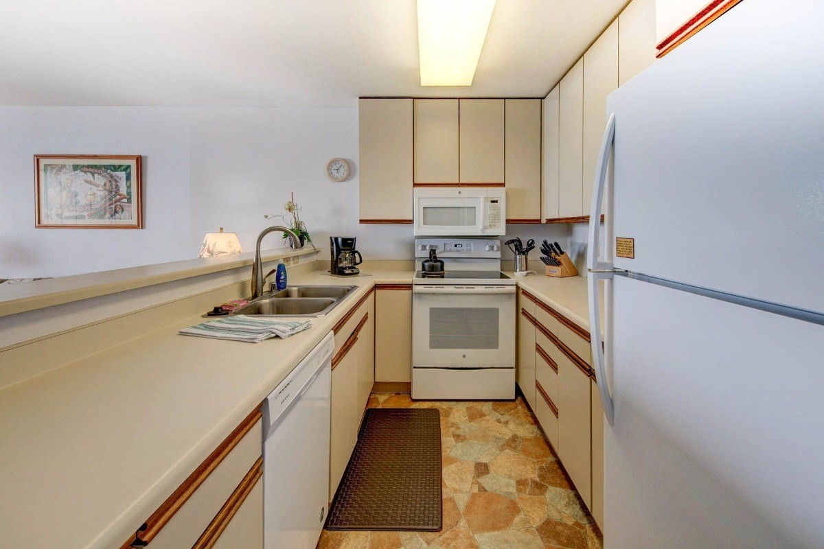 320 Papaloa Road, Unit 213 Kapaa, HI 96746 - Photo 7 of 25 a kitchen with a sink appliances and cabinets