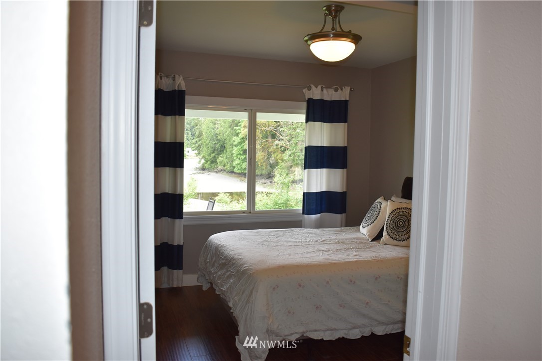10411 Northeast West Kingston Road Kingston, WA 98346 - Photo 15 of 31 a bedroom with a bed and window