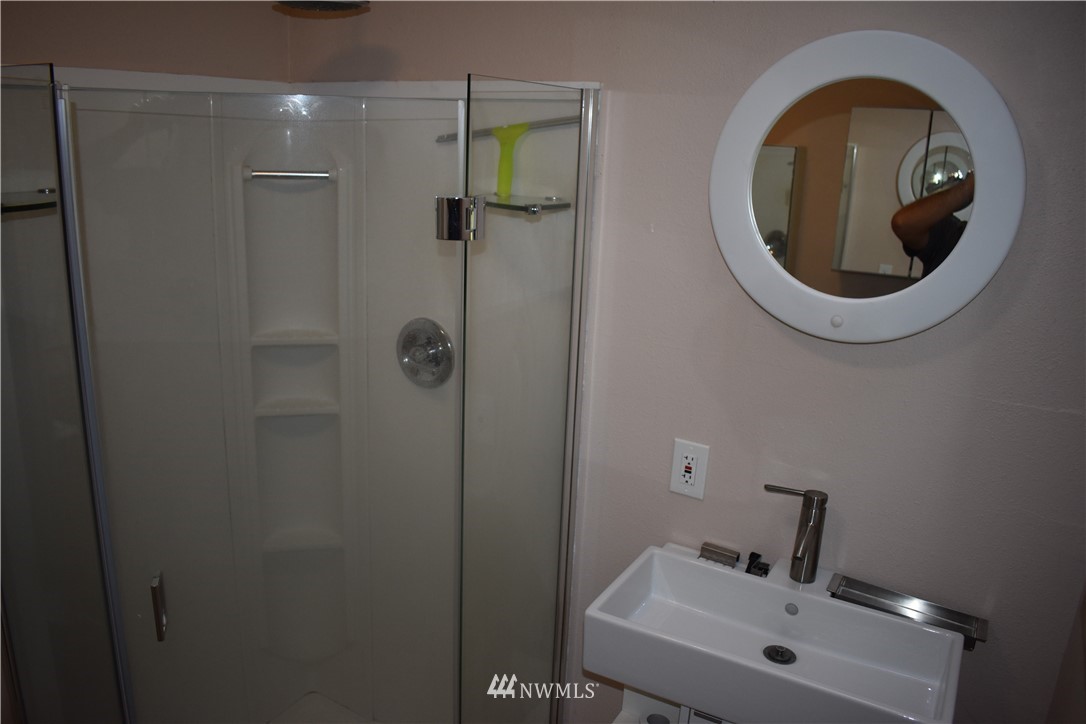 10411 Northeast West Kingston Road Kingston, WA 98346 - Photo 19 of 31 a bathroom with a sink and a mirror