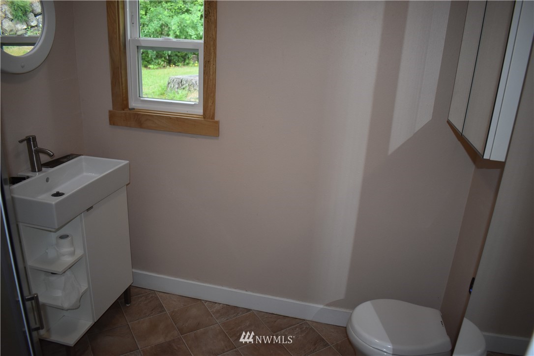 10411 Northeast West Kingston Road Kingston, WA 98346 - Photo 20 of 31 a bathroom with a toilet and a sink