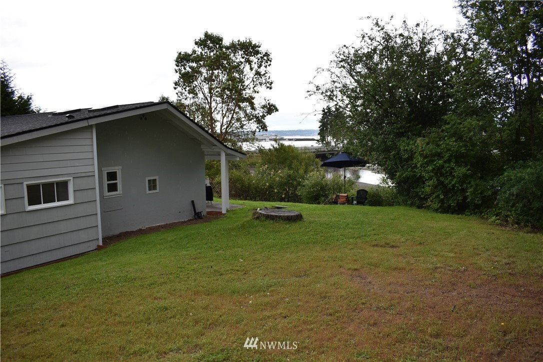 10411 Northeast West Kingston Road Kingston, WA 98346 - Photo 23 of 31 a view of a backyard with a garden