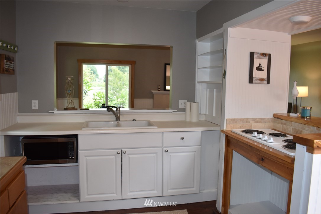 10411 Northeast West Kingston Road Kingston, WA 98346 - Photo 10 of 31 a kitchen with granite countertop a sink and a stove