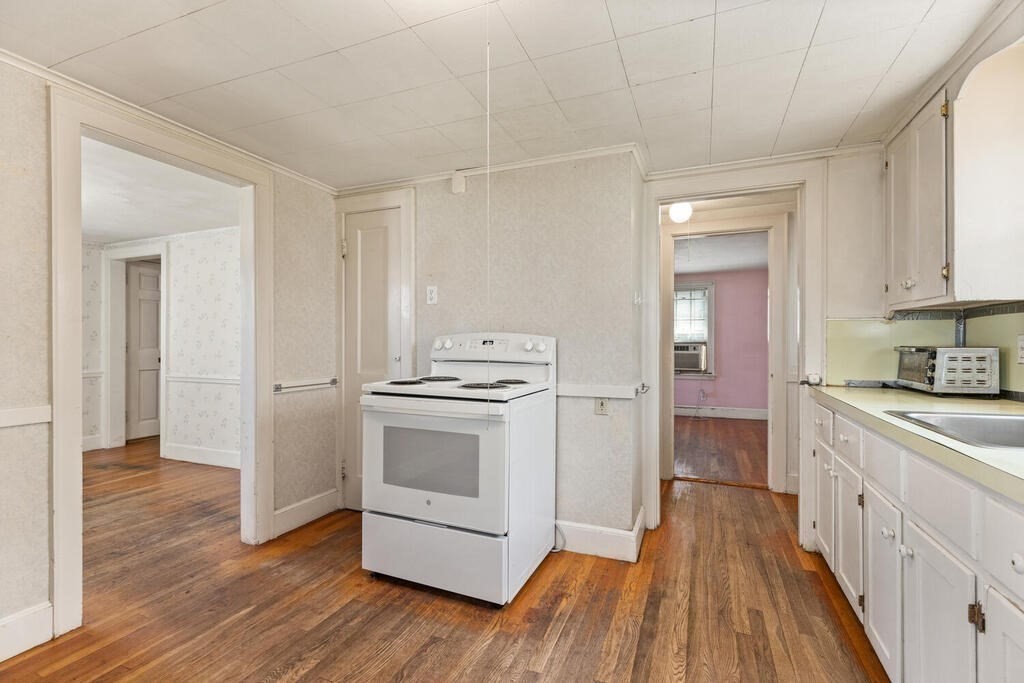 8 Florence Road Waltham, MA 02453 - Photo 15 of 33 a kitchen with granite countertop a sink and a stove top oven