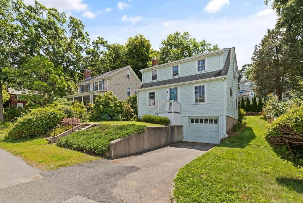 8 Florence Road Waltham, MA 02453 - Photo 2 of 33 a front view of a house with a yard and garage