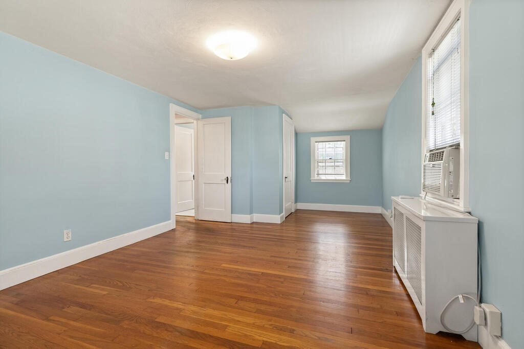 8 Florence Road Waltham, MA 02453 - Photo 21 of 33 a view of an empty room with window and wooden floor