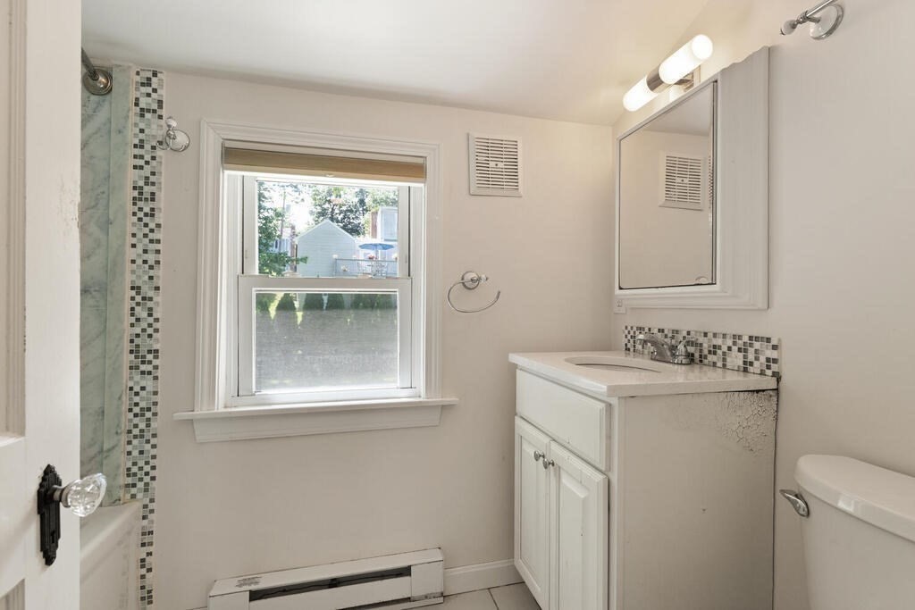 8 Florence Road Waltham, MA 02453 - Photo 23 of 33 a bathroom with a sink a mirror and a shower