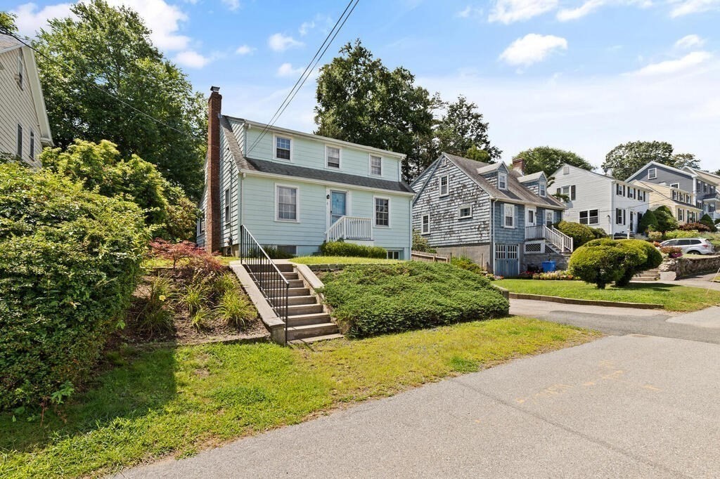 8 Florence Road Waltham, MA 02453 - Photo 3 of 33 a front view of a house with a garden and plants