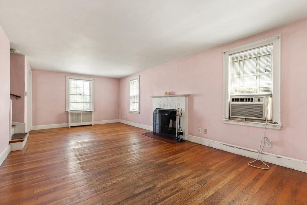 8 Florence Road Waltham, MA 02453 - Photo 8 of 33 an empty room with wooden floor fireplace and windows