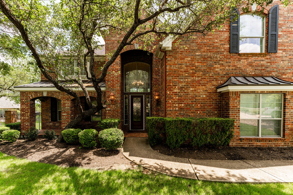 3408 Travis Country Circle Austin, TX 78735 - Photo 2 of 30 View of front of home with a standing seam roof, a metal roof, and brick siding