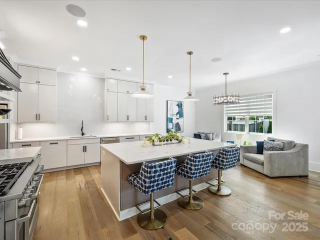 a kitchen with a table chairs stove and kitchen island
