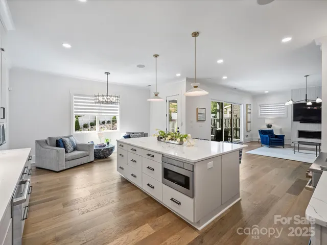 a living room with furniture and kitchen view