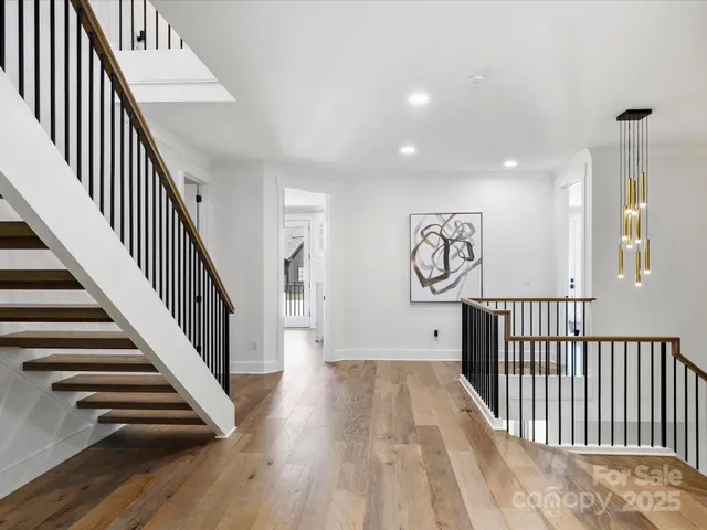 a view of a hallway with wooden floor and entryway