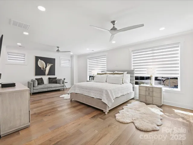 a spacious bedroom with a large bed and a window