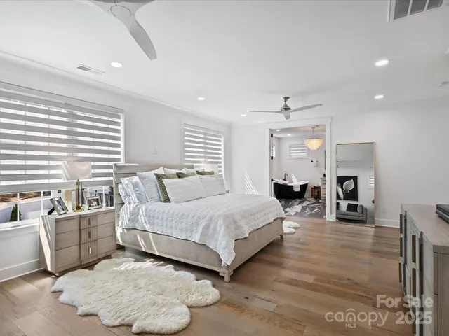 a spacious bedroom with a large bed and a table