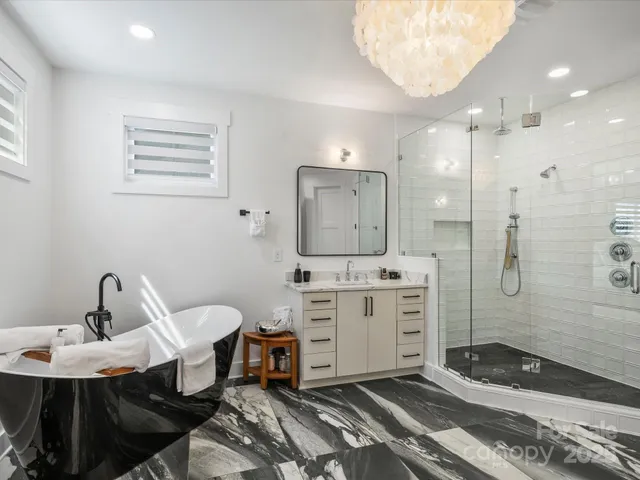 a spacious bathroom with a sink a toilet and shower