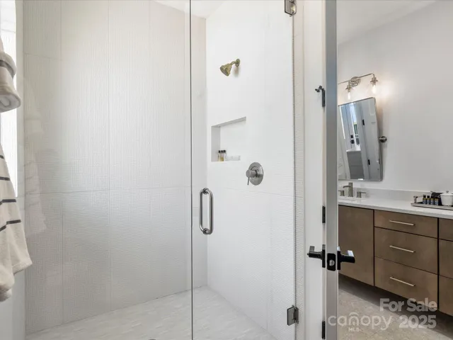 a bathroom with a shower and a sink