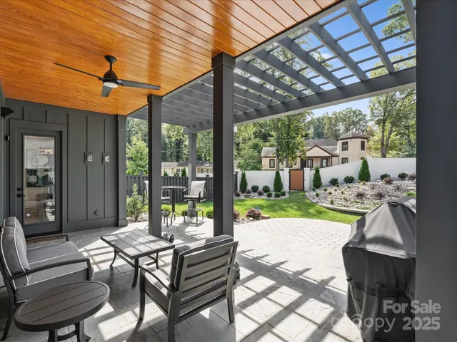 a view of a patio with a table chairs and backyard