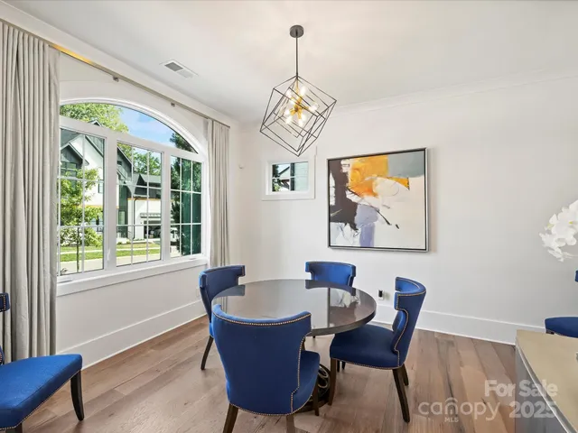 a dining room with furniture a window and a chandelier