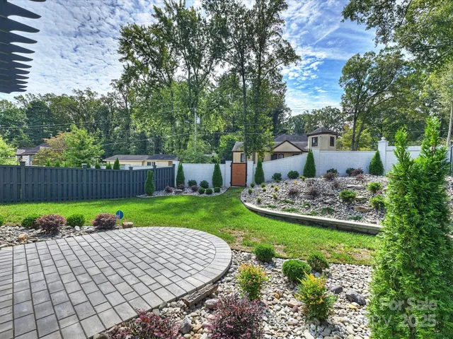 a view of a backyard with garden and plants