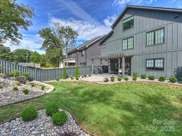 a front view of a house with swimming pool having patio